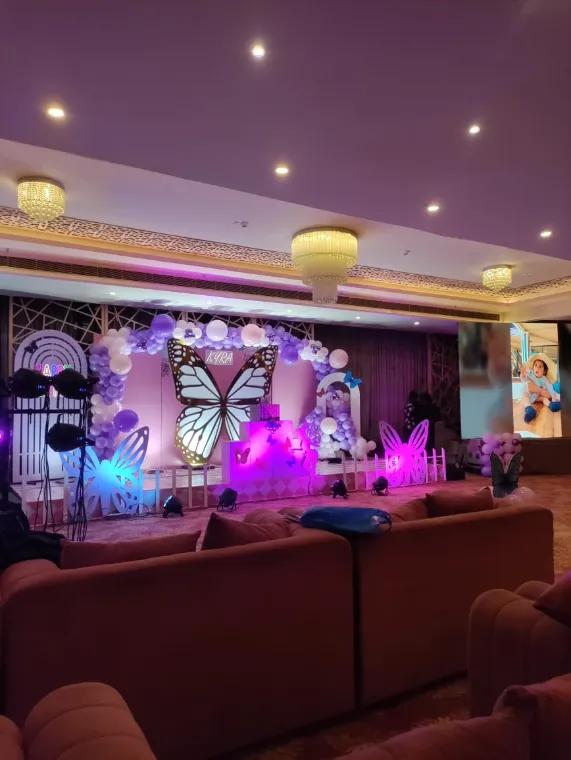 Birthday party setup in a Lucknow banquet hall with lounge seating facing the themed stage