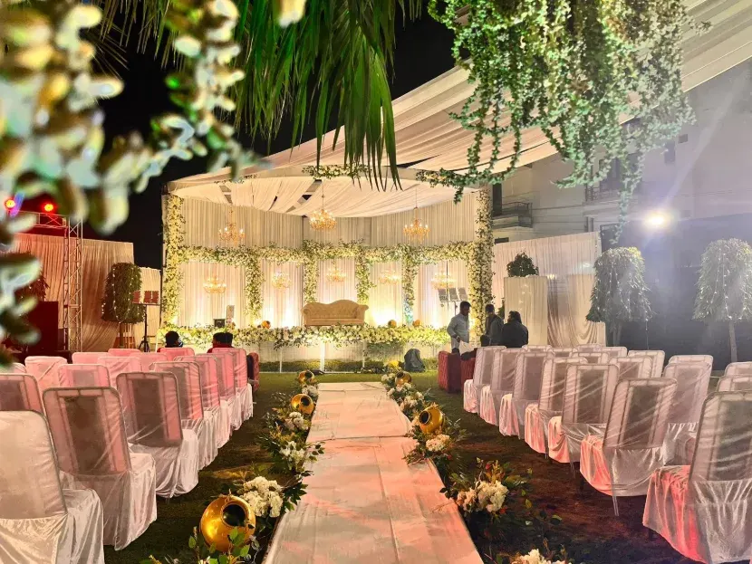 Outdoor wedding ceremony setup with draped aisle and seating, Lucknow
