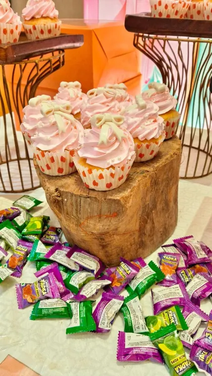 Cupcakes and candy on a rustic dessert table at a Lucknow birthday party